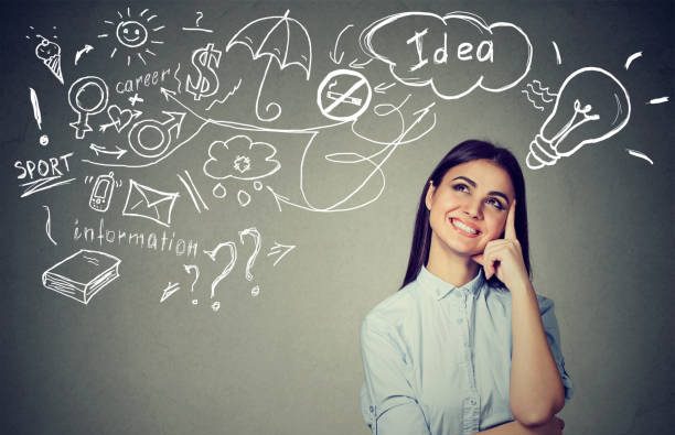 Portrait of a woman thinking dreaming has many ideas looking up at plan isolated on gray wall background. Decision making concept
